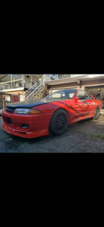 1989 Nissan Skyline GTS-T Type M (R32) in red, showing great condition and custom modifications.