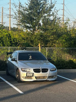 2009 BMW 335i in a parking lot with a clean title, stage 2 modifications, and recent maintenance.