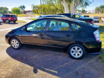 2007 Toyota Prius in black, parked on a sunny day, showcasing its clean exterior and low mileage.