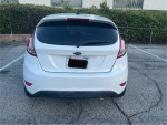 Rear view of a 2015 Ford Fiesta, 83,000 miles, in good condition with clean interior and functional features.