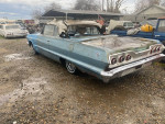1963 Chevrolet Impala Convertible, solid condition with minor rust, parked in a gravel area.