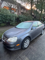 2006 Volkswagen Jetta in excellent condition parked on street with foggy windows and beautiful surroundings.