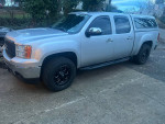 2012 GMC Sierra 1500 SLT 4WD parked with aftermarket upgrades and new tires.