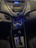 Interior dashboard of a 2013 Hyundai Elantra GL with modern controls and low mileage features.