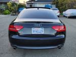 2010 Audi A5 3.2 Premium Plus coupe in black, showcasing Quattro AWD features and sleek design.