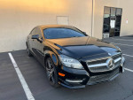 2012 Mercedes-Benz CLS550 in black exterior parked, showcasing elegant design and clean lines.