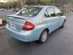 2001 Toyota Prius in light blue parked, showcasing clean exterior and good condition for a reliable, fuel-efficient car.