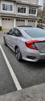2016 Honda Civic EX FWD in silver parked, showcasing its stylish design and features.