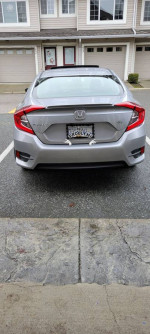 Rear view of a 2016 Honda Civic EX Sedan with sunroof parked outdoors