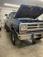 1990 Dodge Ramcharger 4x4 with open hood, showcasing engine and restoration details in garage