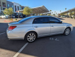 2006 Toyota Avalon XLS in silver with low mileage parked in a sunny area, showcasing its clean exterior.