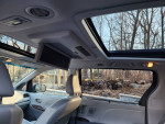 Interior view of a 2011 Toyota Sienna Limited showcasing dual sunroofs and entertainment screen.