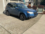 2009 Subaru Forester 2.5X AWD in good condition with clean interior, parked in a driveway