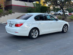 2010 BMW 5 Series 528i sedan in good condition parked, showing its exterior features and stylish design.