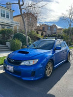 Blue 2013 Subaru Impreza WRX Hatchback parked, showcasing excellent condition and custom features.