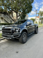 2020 Ford F-150 Raptor 4WD parked on the street, showcasing its sleek design and excellent condition.