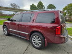 2010 INFINITI QX56 SUV in maroon, featuring third-row seating and a clean title.
