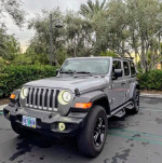 2019 Jeep Wrangler Sport 4WD parked, featuring removable hardtop, premium wheels, and heated seats.