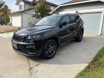 2020 Jeep Cherokee Limited in black, parked in driveway, showcasing stylish design and modern features