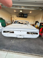 Rear view of a 1969 Chevrolet Camaro project car in a garage, ready for restoration.