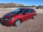 2018 Chevrolet Cruze hatchback parked in a scenic area, showing excellent condition and low mileage.