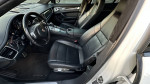 Interior view of a 2011 Porsche Panamera 4 with black leather seats and modern controls