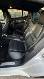 Interior of a 2011 Porsche Panamera 4 AWD with black leather seats and sleek design