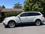White 2013 Subaru Outback with 102,731 miles, needs transmission and catalytic converter, salvage title.