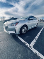 2019 Hyundai Elantra SEL FWD parked with silver exterior, showcasing modern design and features.