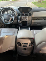 Interior view of a 2014 Honda Pilot EX with leather seating and modern dashboard features