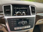 Interior view of a 2015 Mercedes ML350 with navigation system and audio controls.
