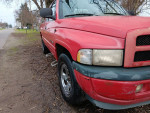 Red 1998 Dodge Ram truck with minor body dents and new steering components, suitable for mechanical repairs.