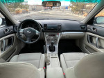 2009 Subaru Outback interior view with manual transmission, featuring comfortable seating and modern controls.