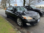 2009 Hyundai Genesis sedan in black, showcasing polished alloy wheels and sleek design.