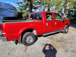 2002 Ford F250 Superduty XLT Crew, red pickup truck with a spacious bed and well-maintained exterior.