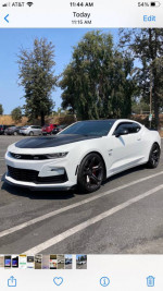 2021 Chevrolet Camaro SS 1LE in immaculate condition, parked with trees in the background, showcasing its sleek design.