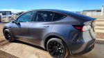 2023 Tesla Model Y Long Range SUV with oversized black wheels, in excellent condition