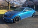 2003 Infiniti G35 Coupe in blue, showcasing sleek design and leather interior, parked outdoors.