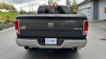 Rear view of a 2016 Dodge Ram 1500 Laramie Longhorn with running boards and license plate visible.