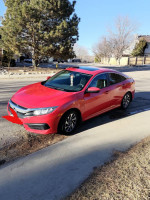 2016 Honda Civic EX in Rallye Red parked on the street with a clear sky background