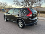 2013 Honda CR-V in good condition with clean interior and exterior, showcased in a suburban street view.