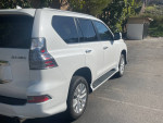 2021 Lexus GX 460 4WD in Starfire Pearl White with Black Leather, showing sleek design and chrome accents.