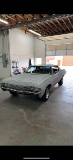 1968 Chevrolet Impala Custom Coupe parked in a garage, excellent condition with 62,000 miles, ready for sale.