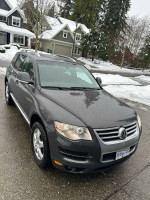 2010 Volkswagen Touareg TDI Highline in excellent condition with winter tires and towing hitch parked in snowy area