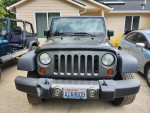 Front view of a 2010 Jeep Wrangler Mountain Edition, showing its unique grille and rugged design.