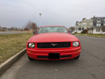 Front view of a 2007 Ford Mustang in red, showcasing premium features and distinct style.