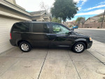 2009 Chrysler Town and Country Limited in metallic gray parked on driveway, showcasing exterior and alloy wheels.