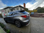 2021 Lexus RX 450 Hybrid parked in a driveway, showcasing a sleek design and luxurious features.