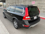 2015 Volvo XC70 in black, showing rear view, well-maintained with good tires and clean appearance.