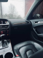 Interior view of a 2013 Audi A4 2.0T Premium, featuring leather seats and premium sound system.